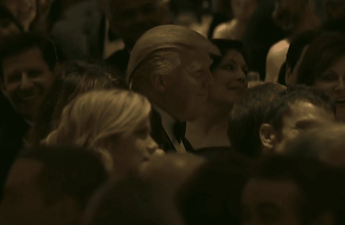 Audience at formal event, smiling attendees.
