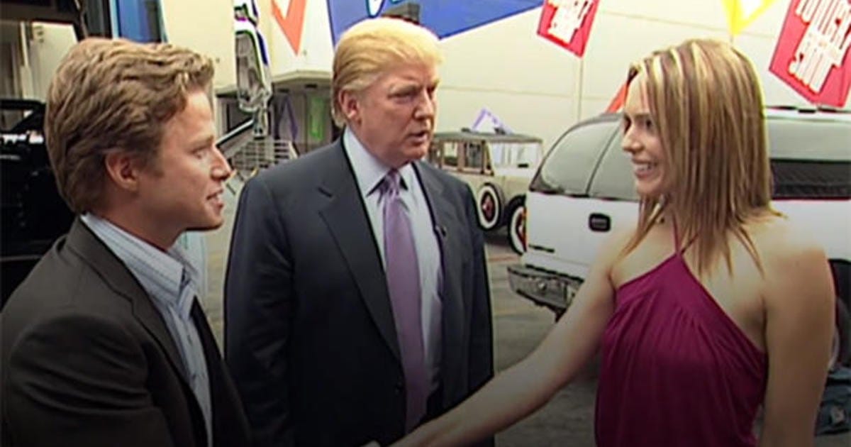 Three people greeting at an event.