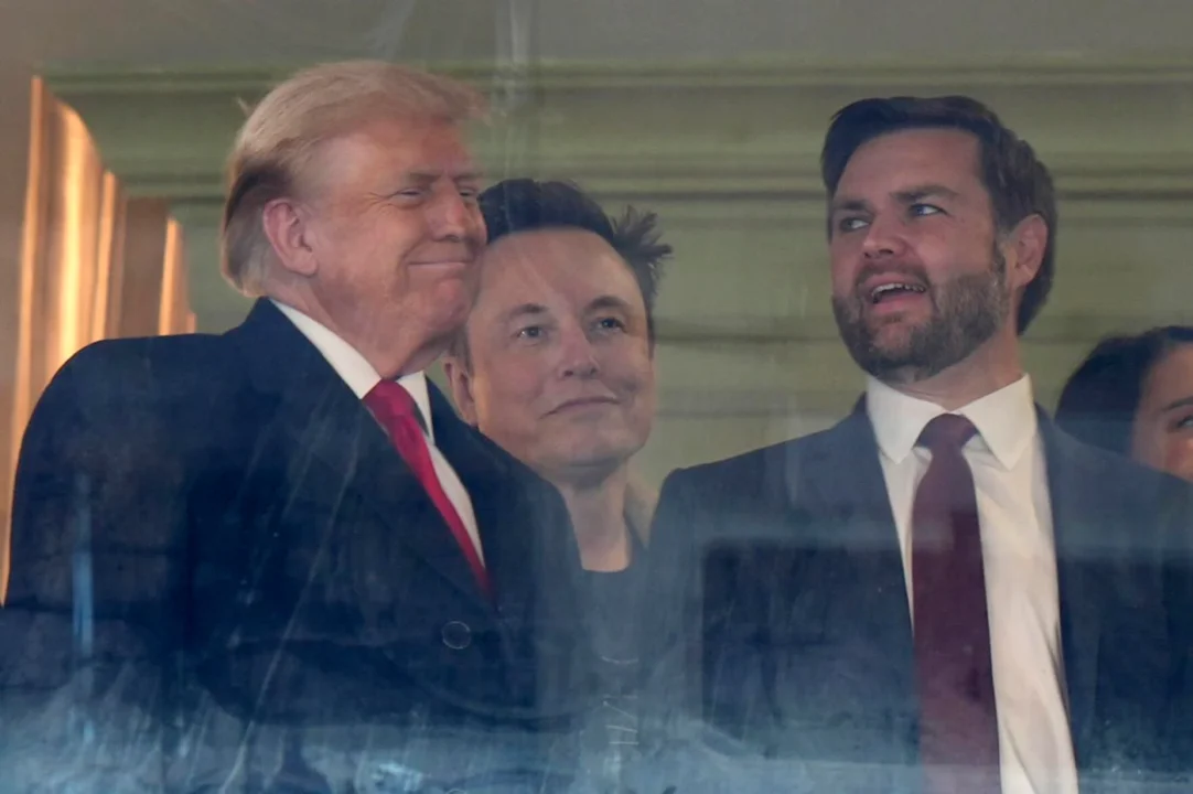 Trump, Musk, and eyeliner-wearing JD Vance at a football game loking like they all just gooned.