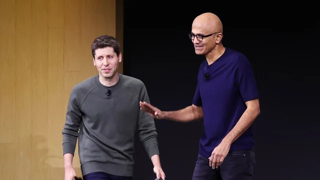 Two people speaking at a tech conference event.